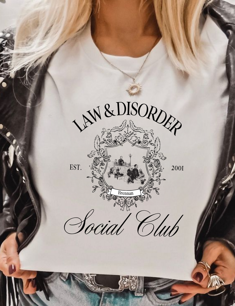 Close-up of Law and Disorder tee print in bold black serif letters.”